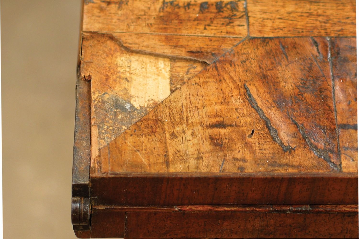 Detailed view of a weathered wooden table, highlighting intricate grain patterns and joints that reflect its rustic craftsmanship.