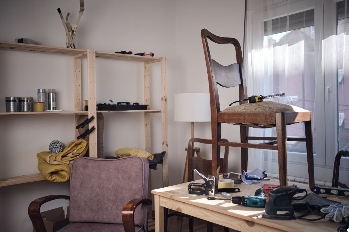  A single chair positioned on a table, creating a unique visual contrast between the two pieces of furniture.