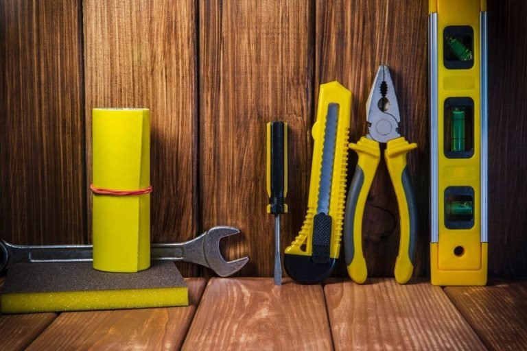 Tools laid out on a wooden backdrop, providing a spacious area for potential text or messaging.